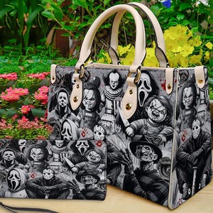 May include: A gray handbag and matching wallet set featuring a horror movie character design. The handbag has cream-colored handles and accents. The wallet has a wrist strap. The design includes characters like Chucky, Freddy Krueger, and Jason Voorhees.