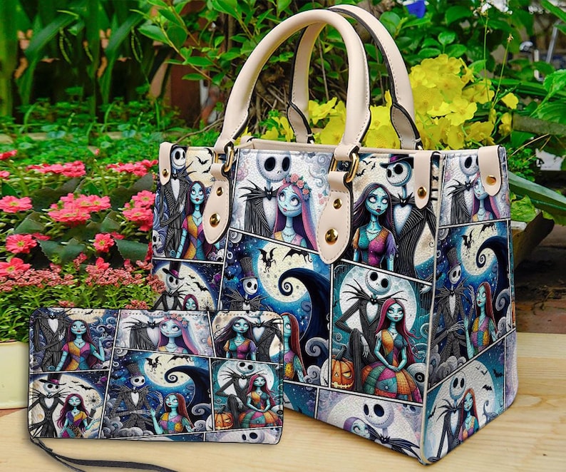 May include: A handbag and matching wallet featuring a collage of characters from a popular animated film. The bag has cream-colored handles and accents. The collage includes images of a skeleton-like figure, a rag doll, and a full moon.