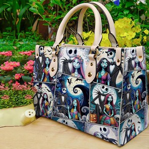 May include: A patterned handbag featuring characters from "The Nightmare Before Christmas." The bag has a cream-colored handle and trim, with a collage of images depicting Jack Skellington, Sally, and other characters against a blue night sky background.