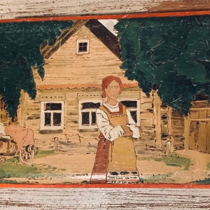 May include: A hand-painted wooden box with a scene of a woman standing in front of a house. The house is brown with white windows and a red roof. The woman is wearing a red and white dress and holding a basket. The background is a green field with trees.