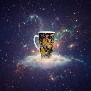 May include: Tall coffee mug with a white handle and rim, featuring a colorful abstract design in black, yellow, and orange. The mug appears to be sitting on a cloud against a backdrop of a starry galaxy.