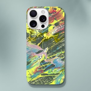 May include: A smartphone case with a vibrant abstract design. The case features a colorful splatter paint effect with yellow, red, blue, and black hues. The design covers the entire back of the phone case.