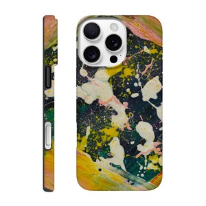 May include: A colorful phone case with an abstract paint splatter design. The case features a dark background with yellow, white, pink, and green paint splatters. The side of the case is a mix of colors, including yellow, pink, and green.