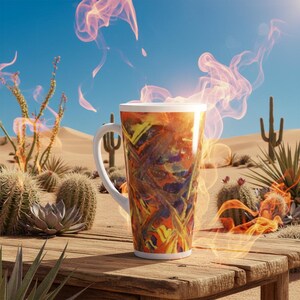 May include: A tall, white-handled coffee mug with a colorful, abstract design of orange, yellow, and blue. The mug is set on a weathered wooden table in a desert scene with cacti and a blue sky. Wisps of orange smoke rise from the mug.