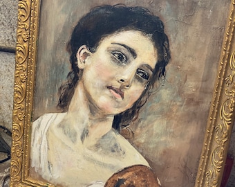 May include: A framed oil painting of a woman with dark hair and a white blouse. The painting is in a gold frame with ornate details.