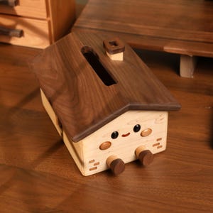 May include: A rustic wooden sign with the text "Welcome to our home" in white lettering. The sign features a distressed finish and a simple, inviting design, perfect for a front porch or entryway.