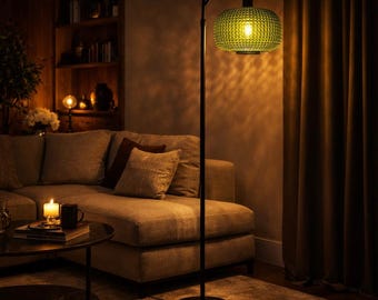 May include: A floor lamp with a thin black metal stand and a round base, featuring a textured, translucent green glass shade that emits a warm, glowing light. The lamp has a curved top arm that suspends the glass shade downward.
