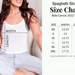 May include: White spaghetti strap tank top with a size chart. The chart lists measurements in inches for sizes XS to 2XL. The tank top is Bella Canvas 1012 Tank. The width measurements range from 33.66 cm to 45.09 cm, and the length measurements range from 31.12 cm to 35.86 cm.