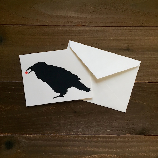 raven with a red berry in its beak greeting card