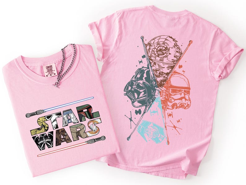 K&ouml;nnte beinhalten: Zwei rosa T-Shirts mit Star Wars-Grafiken. Eines zeigt den Text "STAR WARS" mit Charakterillustrationen und Lichtschwertern. Das andere zeigt Darth Vader, einen Sturmtruppler und den Todesstern. Eine silberne Kette befindet sich auf einem T-Shirt.