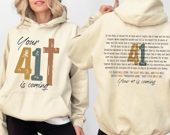 May include: Cream-colored hoodie with a front graphic that reads "Your 41 is coming" with a cross and the number 41 in various colors. The back of the hoodie has a biblical passage and the same phrase.