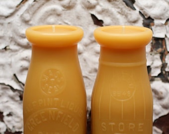 Two - antique bottle-shaped beeswax candles - "GREENFIELD DAIRY half PINT" & "5 Cent Dairy" - by Pollen Arts - Md.