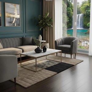 May include: A modern living room with a gray sectional sofa, a marble-topped coffee table, and a patterned rug. The room features a large window with a view of a waterfall and lush greenery. Decorative vases and artwork add to the room's aesthetic.