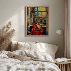 May include: A framed painting of a red electric guitar leaning against a window. The guitar has a gold pickguard and black knobs. The window has a colorful, abstract design. The painting is in a bedroom setting.