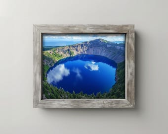 May include: A framed print featuring a vibrant blue lake surrounded by a mountainous landscape. The water reflects the sky and clouds. The frame is made of weathered gray wood, adding a rustic touch to the scenic artwork.