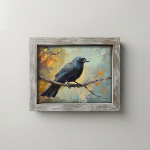 May include: A framed painting of a black crow perched on a branch. The artwork features a muted color palette with shades of blue, orange, and yellow. The crow is the focal point, set against a soft, textured background.