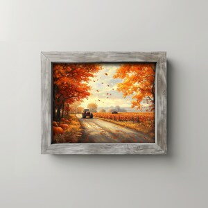 Puede incluir: Pintura de paisaje enmarcada que representa una escena otoñal. Un tractor rojo viaja por un camino de tierra bordeado de árboles con un vibrante follaje naranja y rojo. Se ven calabazas a la izquierda. El cielo es una mezcla de azul y blanco.