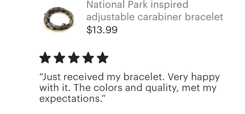 May include: A National Park-inspired adjustable carabiner bracelet. The bracelet is a braided design in shades of gray and green. The image also includes a customer review with five stars.