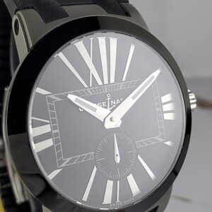 May include: A dark grey wristwatch with a black bezel and a black rubber strap. The watch face is grey with white Roman numerals and hands. The words "SWISS MADE" are printed at the bottom of the watch face.