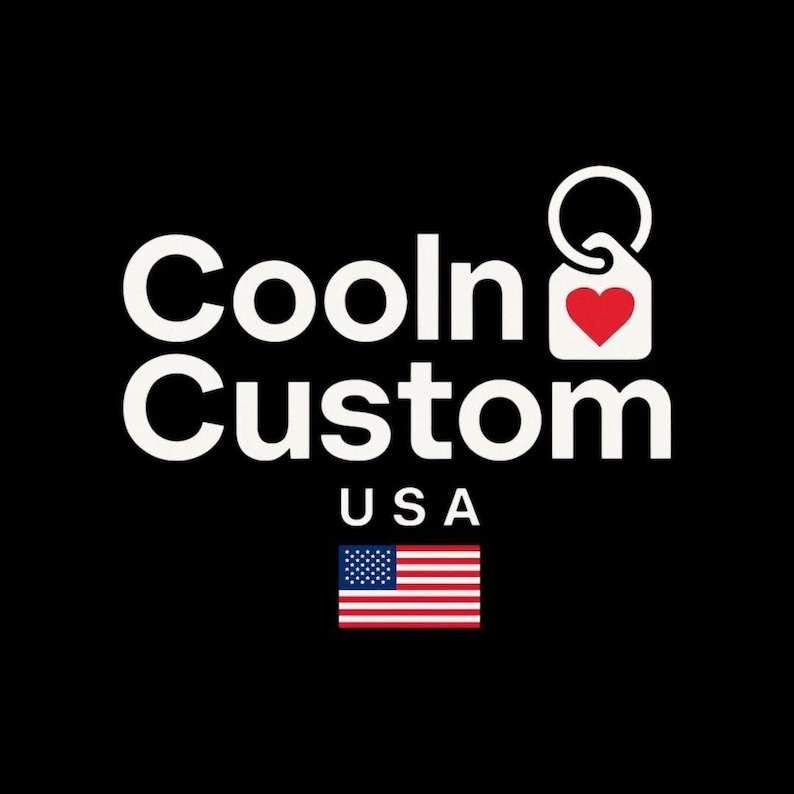 May include: The words "Cooln Custom" in white, with "USA" below, and an American flag graphic on a black background. A white tag with a red heart is attached to a keyring.