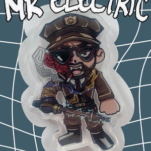 May include: A cartoon-style sticker featuring a character with a military hat, sunglasses, and a partially exposed brain. The character is holding a weapon and smoking a cigarette. The sticker has the text "MR ELECTRIC" at the top.