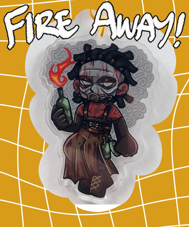 May include: A cartoon-style acrylic charm featuring a character holding a flaming bottle. The character wears a mask and a red shirt, with the words "FIRE AWAY!" above. The background is yellow with a white grid.