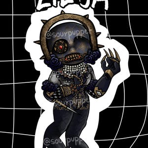 May include: A sticker featuring a stylized illustration of a doll-like figure named Lilya. The figure has a dark face with a decorative headpiece, a necklace, and a patterned outfit. The background is a black and white grid.