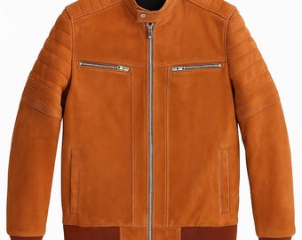 May include: A tan leather jacket with a stand-up collar and a zip-up front. The jacket has two zippered chest pockets and two side pockets. The sleeves have ribbed cuffs. The shoulders and sleeves have quilted detailing.