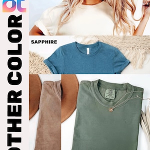 May include: A product image showcasing t-shirts in various colors: ivory, sapphire, espresso, and moss. The image includes the text "OTHER COLOR" and "COLOR: ESPRESSO". The shirts are displayed with rolled-up sleeves and a crew neck.