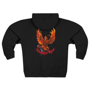 May include: Black zip-up hoodie featuring a vibrant phoenix design in shades of red, orange, and yellow on the back. The words "Always Rise" are written in red script below the phoenix. The hoodie has a hood and a full-length zipper.