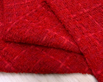 May include: Close-up of a vibrant red woven fabric. The material has a textured, cross-hatched pattern, with visible threads creating a rich, tactile surface. The fabric is folded, showcasing its depth and drape. Ideal for apparel or home decor.