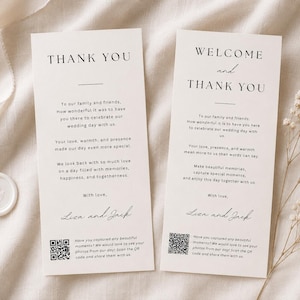 May include: Two vertical off-white wedding thank you cards with black serif and script typography. The text includes "THANK YOU" and "WELCOME and THANK YOU" with a QR code at the bottom of each card. The cards feature a minimalist layout design.