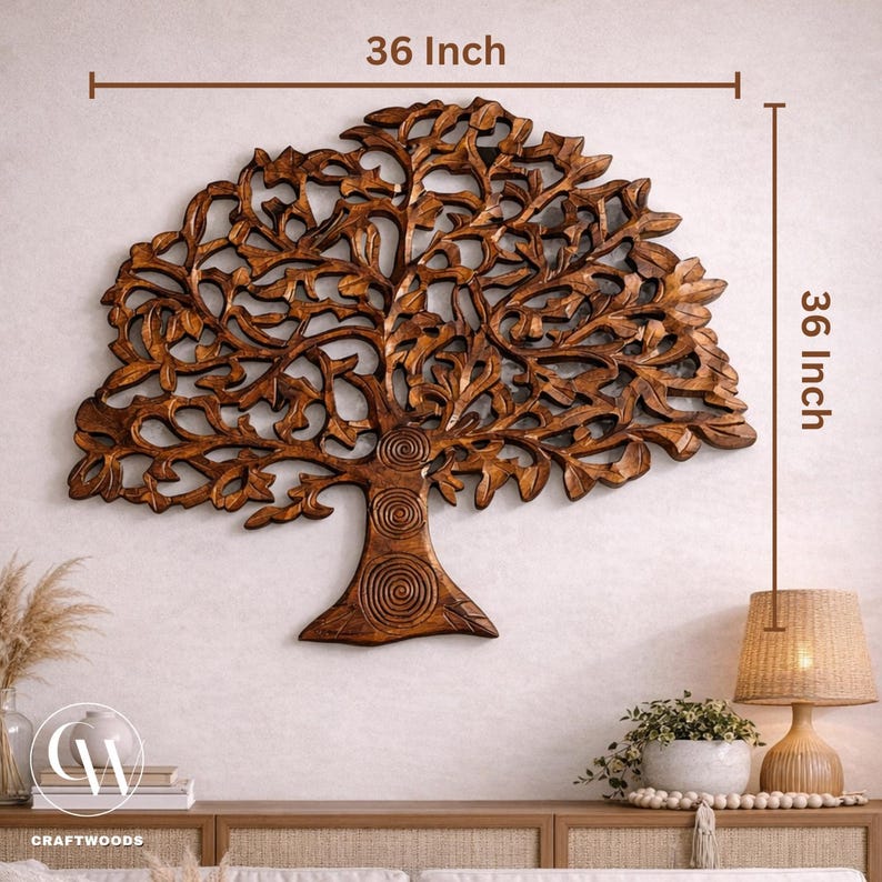 May include: A wooden tree wall art piece, measuring 91 cm by 91 cm. The tree is intricately carved with detailed leaves and branches. The trunk features spiral designs. The artwork is a warm brown colour and is mounted on a neutral wall.