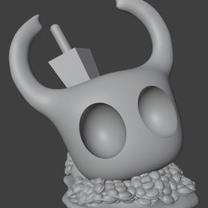 May include: A 3D-printed, light gray figurine of a character with large horns, large eye sockets, and a small, square object on top. The base of the figurine has a textured, rounded design. The figurine is set against a gray background.