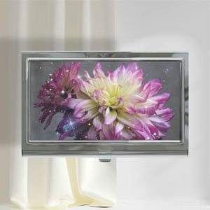 May include: A rectangular silver metal business card case featuring a glossy top panel with a vibrant floral print. The design displays a large, multi-petaled dahlia flower in shades of white, soft yellow, and deep magenta against a dark background.