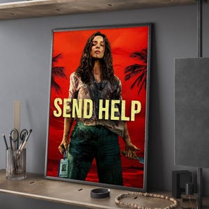 May include: Framed poster with a woman against a red background, text reads "SEND HELP". The woman is wearing a distressed shirt and green pants, holding a knife and an ID badge. Palm trees are visible.
