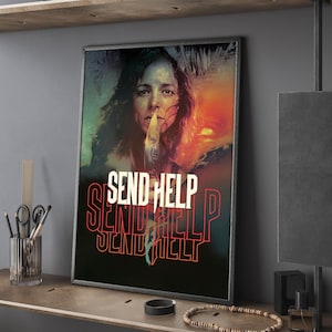 May include: Framed art print featuring a woman with a knife, the text "SEND HELP" in red and white. The artwork has a dark, dramatic color palette with a sunset in the background. The print is displayed on a wooden shelf.