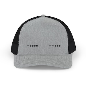 May include: A grey trucker cap with a black mesh back and a curved peak. The front displays black dots and dashes in Morse code. A classic hat for everyday wear.