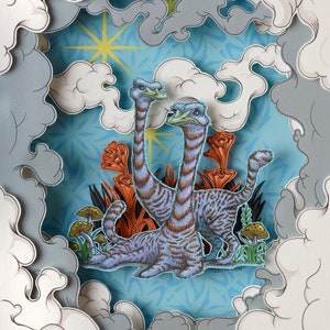 May include: A layered paper art piece featuring two long-necked creatures with blue and brown striped bodies, set against a blue background with orange plants and mushrooms. The artwork is framed by stylized clouds.