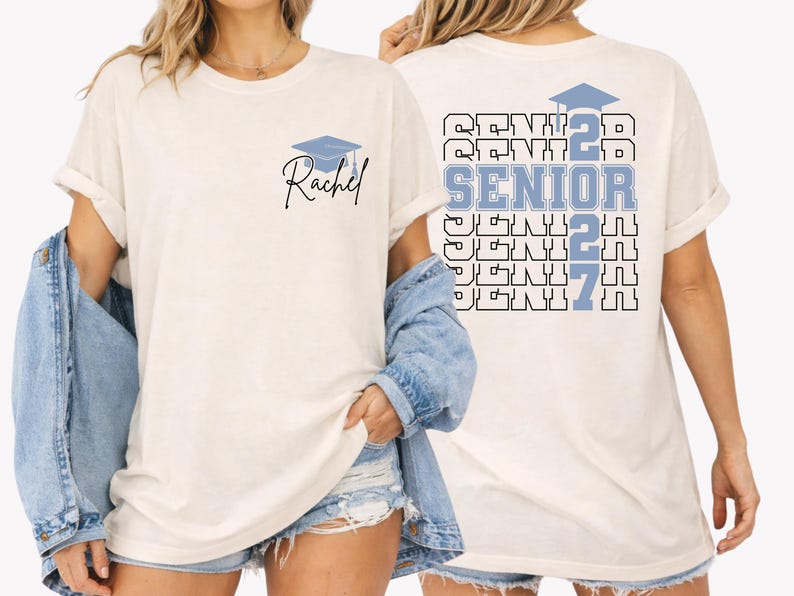 Custom Class of 2027 graduation shirt showcasing bold layered senior lettering, graduation cap artwork and personalized student name design on a relaxed fit Comfort Colors tee for graduation parties and senior photos. Blue Comfort Colors senior graduation shirt with personalized name detail, bold Senior 2027 typography and graduation themed artwork created for students celebrating their final year of high school.