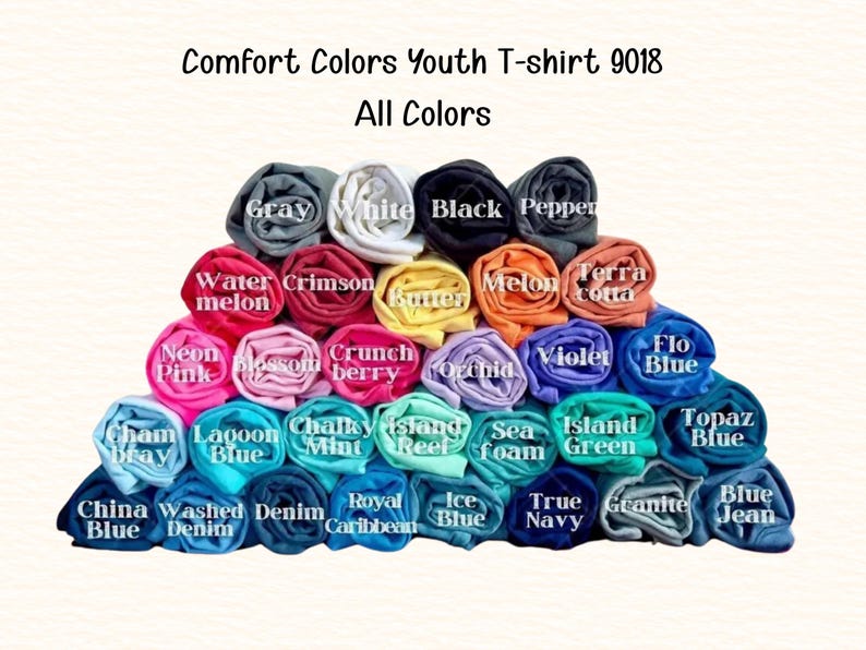 A colorful pyramid of rolled-up t-shirts in various colors, including gray, white, black, red, pink, blue, green, purple, orange, yellow, and more.