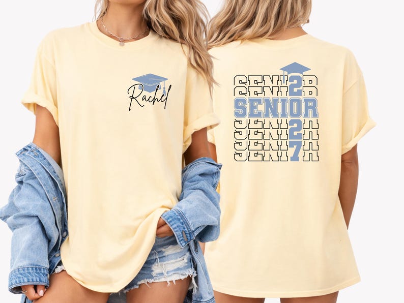 Senior year 2027 shirt featuring custom name personalization, repeating senior typography and graduation inspired graphics displayed on a blue Comfort Colors t shirt ideal for school spirit events and graduation season. Personalized graduation apparel with bold Senior 2027 design, graduation cap illustration and custom student name printed on a comfortable oversized Comfort Colors shirt for graduating high school seniors.