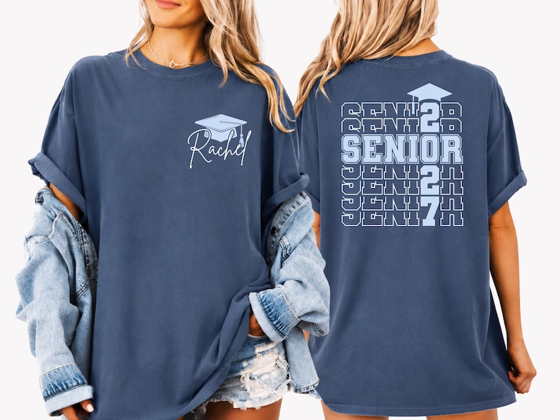 Personalized Senior 2027 Comfort Colors shirt featuring stacked repeating senior typography, graduation cap graphic and custom name detail printed on a vintage blue oversized t shirt, perfect for high school senior celebrations and graduation events. Personalized senior apparel featuring graduation cap illustration, repeating Senior 2027 lettering and custom name design on a vintage inspired Comfort Colors shirt for senior photos and school events.