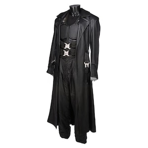 May include: A black leather costume displayed on a mannequin. The costume includes a long coat, a vest with silver buckles, and matching pants. The coat has a classic trench coat design.