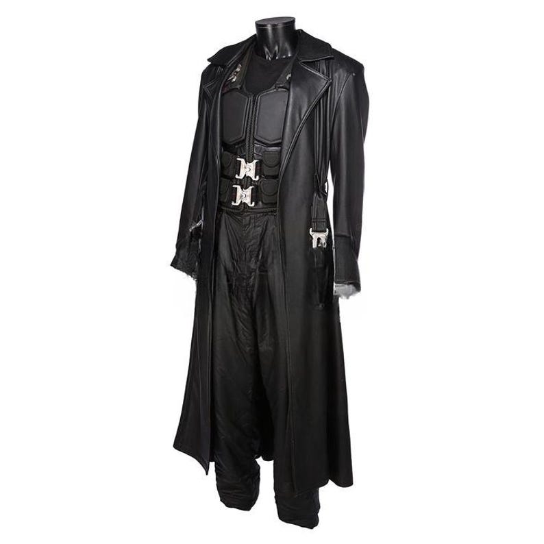 May include: A black leather costume displayed on a mannequin. The costume includes a long coat, a vest with silver buckles, and matching pants. The coat has a classic trench coat design.