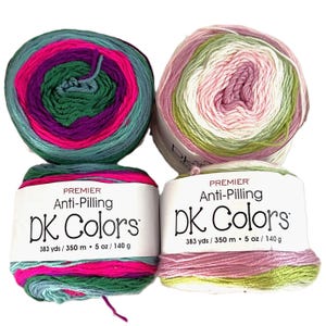 May include: Two skeins of Premier DK Colors anti-pilling yarn. One skein features teal, pink, purple, and green, while the other has pink, white, and green. Each skein is labeled with the text "Premier Anti-Pilling DK Colors" and contains 383 yards of yarn.