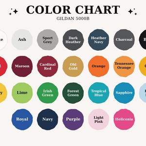 May include: A Gildan 5000B color chart featuring twenty-eight circular swatches labeled with color names including White, Ash, Sport Grey, Dark Heather, Heather Navy, Charcoal, Black, Red, Maroon, Cardinal Red, Old Gold, Orange, Tennessee Orange, Gold, Daisy, Lime, Irish Green, Forest Green, Tropical Blue, Sapphire, Light Blue, Royal, Navy, Purple, Light Pink, and Heliconia.