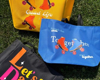 May include: Three tote bags with roller skate designs on a grassy surface. A yellow bag features orange skates and the text "Quad Life." A blue bag has orange and blue skates with the text "Friends that skate together stay together." A black bag displays "Let's Dance."