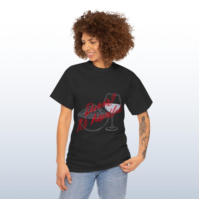 May include: Black t-shirt featuring a graphic of popcorn and a wine glass. The text on the shirt reads "Do what feels right". The design is in red and white.