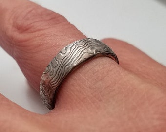 Rustic texture finish on white gold and sterling mokume gane with fine river wedding band